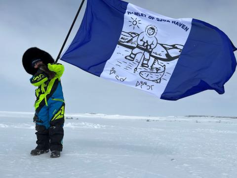 child with gjoa haven flag
